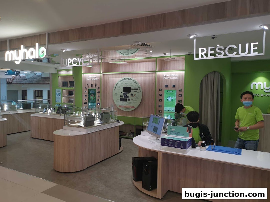 Interior of a modern tech shop with display cases and staff.