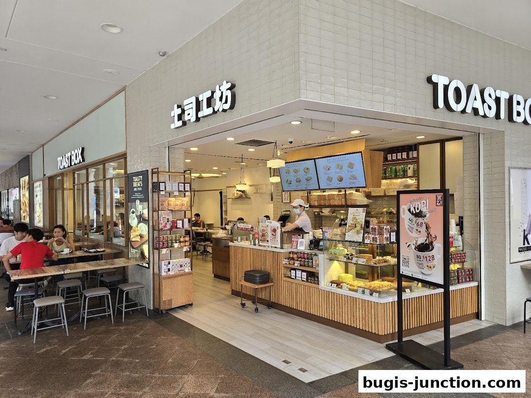 Toast Box Bugis Junction shop front with seating area and display of food items.