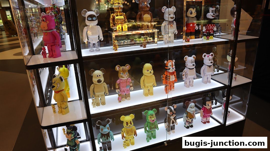 A display case filled with various collectible designer toys, including Bearbrick figures.