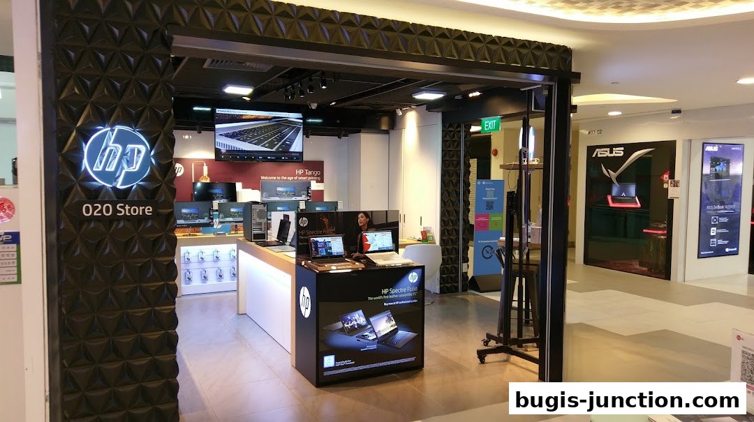 Interior view of the HP O2O Store showcasing laptops and computers, with an adjacent ASUS store.