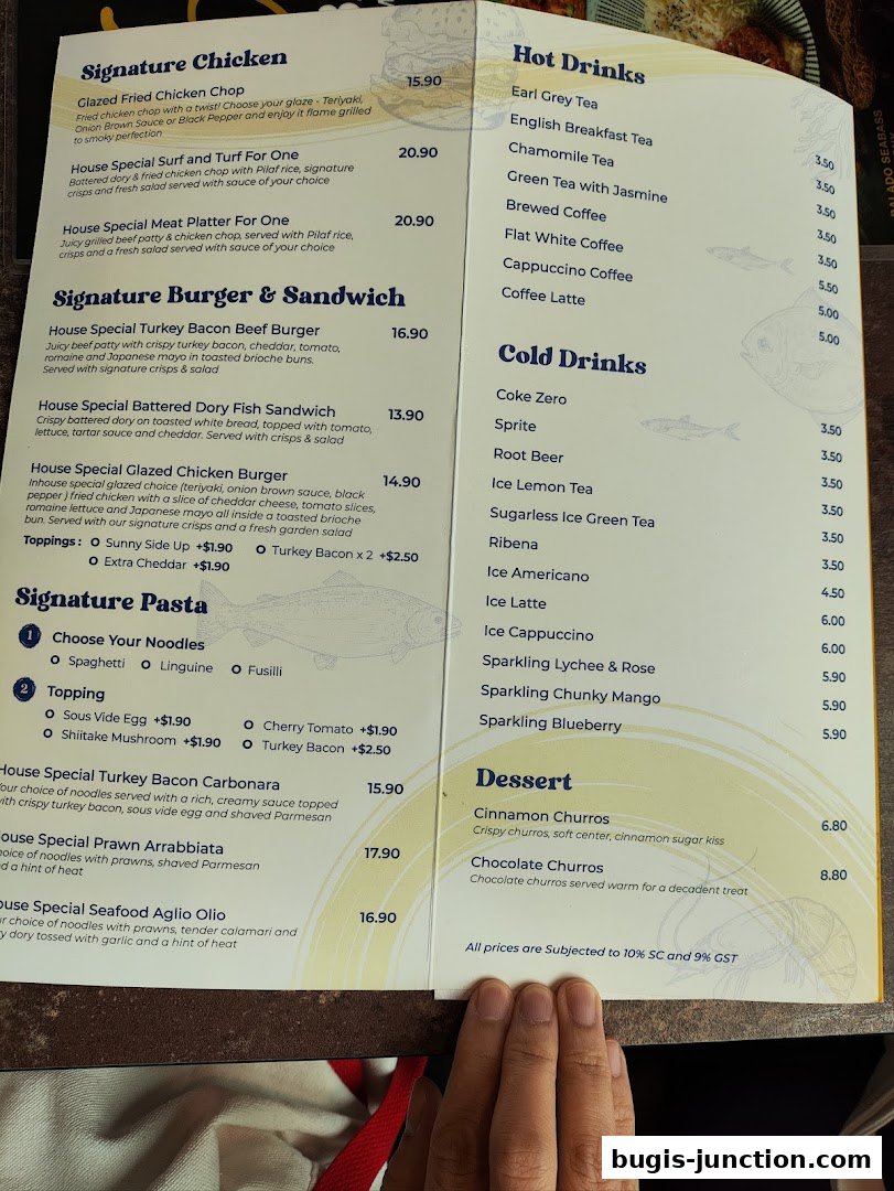 A menu from Big Fish Small Fish Bugis Junction featuring signature chicken, burgers, pasta, drinks, and desserts.