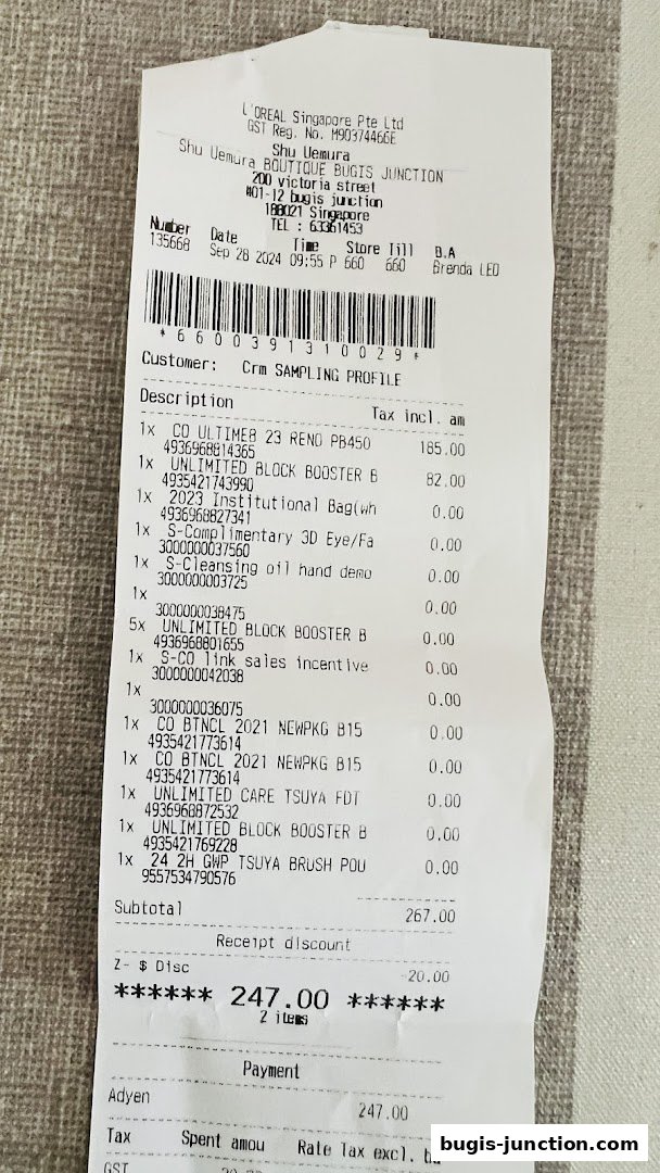 A receipt from Shu Uemura Boutique Bugis Junction showing purchased items and total amount.