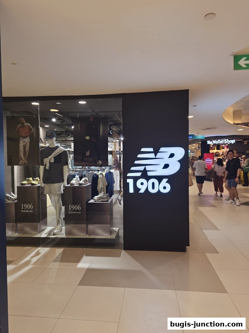 New Balance store front with mannequins displaying apparel and shoes, and the brand's logo.