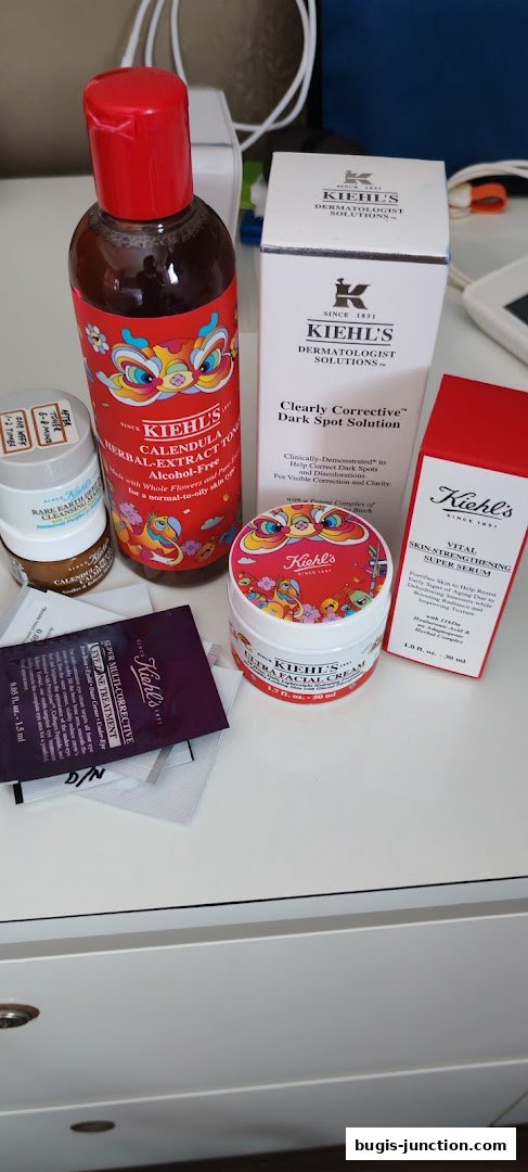 A collection of Kiehl's skincare products, including a toner, serum, cream, and eye treatment.
