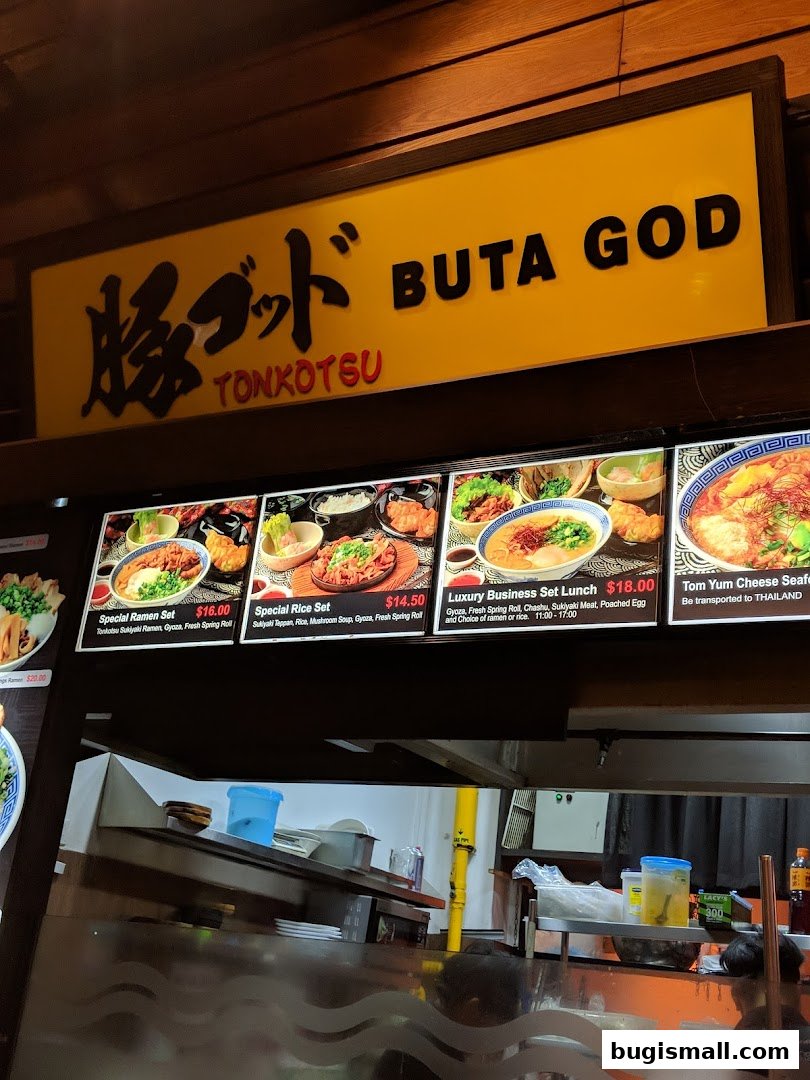 A sign for 'Buta God Tonkotsu' with a display of ramen and set meals.