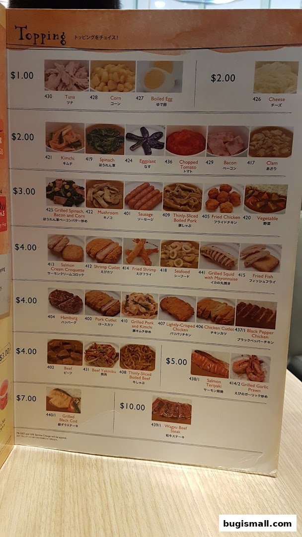 A menu from CoCo Ichibanya featuring various toppings and dishes with prices.