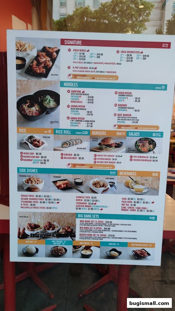 A menu board for JINJJA Chicken featuring various Korean fried chicken dishes, noodles, rice, sides, and beverages.