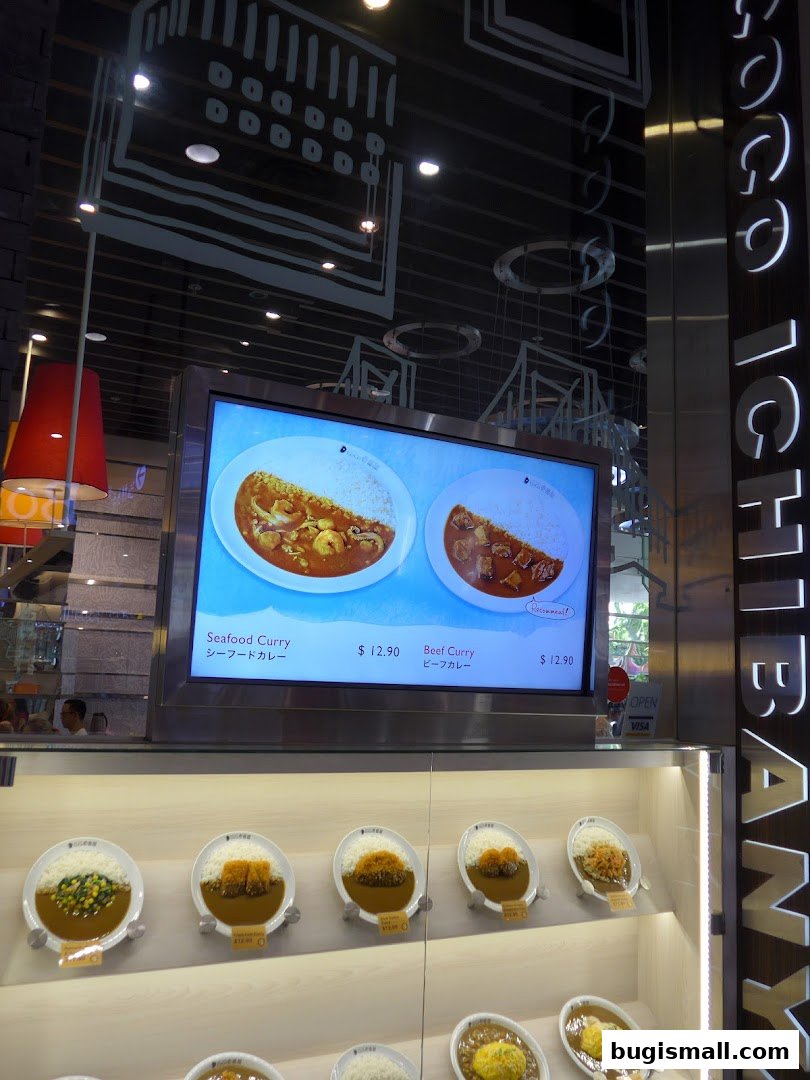 Display of Japanese curry dishes at CoCo Ichibanya, featuring seafood and beef curry.