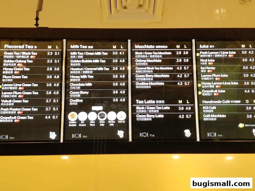 A menu board displaying various tea, macchiato, latte, and juice options with prices.