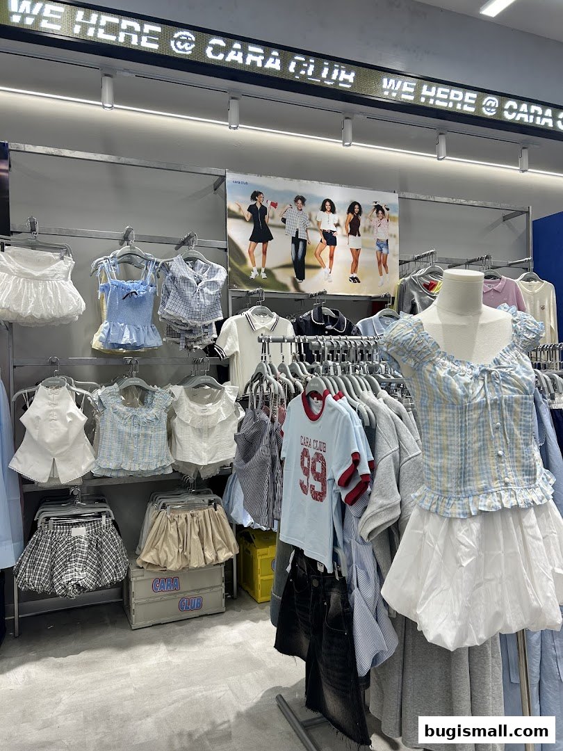 A clothing store interior with various women's apparel displayed on racks and a mannequin.