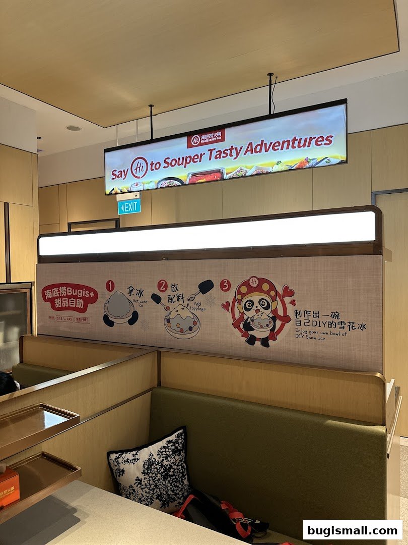 Interior of a Haidilao Hot Pot restaurant with seating and a promotional sign.