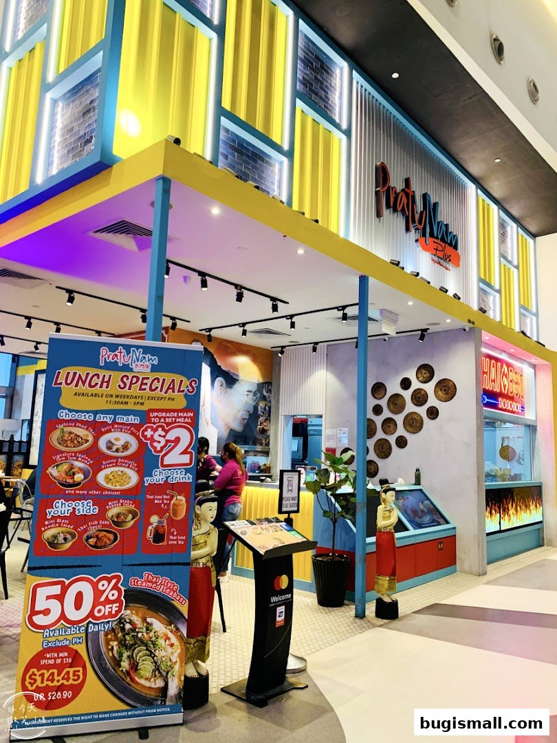 A brightly lit Thai restaurant with a colorful facade and a prominent lunch special sign.