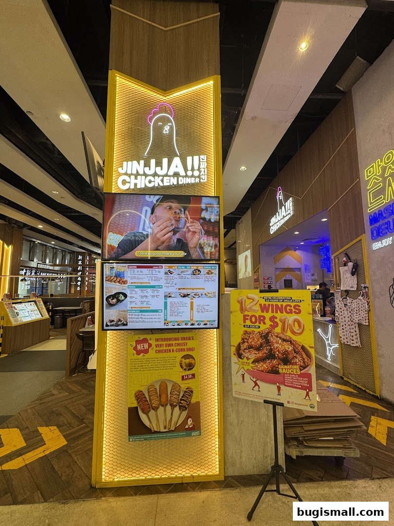 JINJJA Chicken Diner storefront with digital menus and promotional posters.