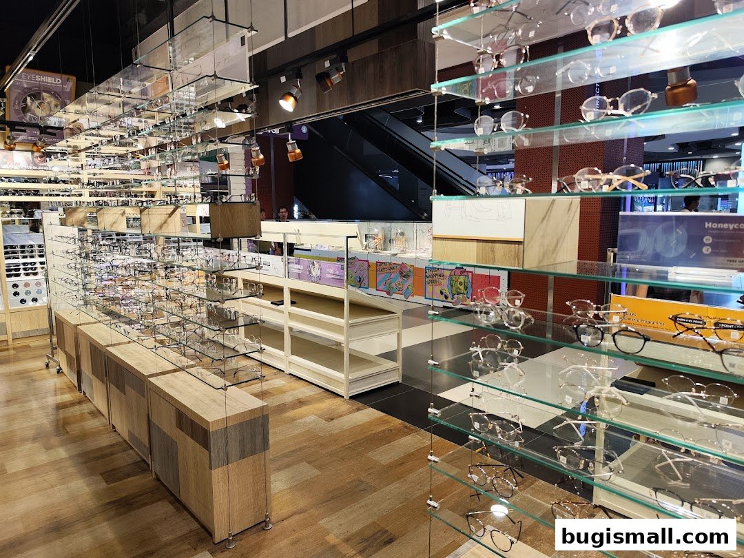 Interior view of an eyeglasses store showcasing a wide selection of frames on display shelves.