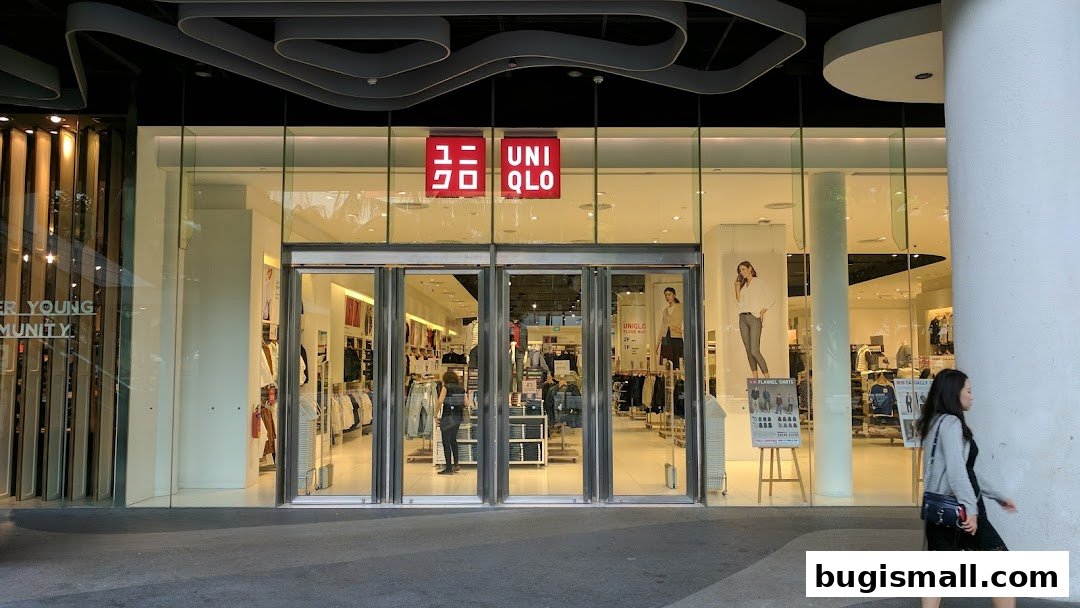 The exterior of a UNIQLO store with its iconic red logo and glass doors.