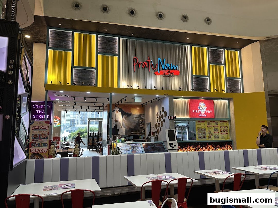 The exterior of Pratunam PLUS by Soi Thai Soi Nice, a Thai restaurant with vibrant decor and seating.