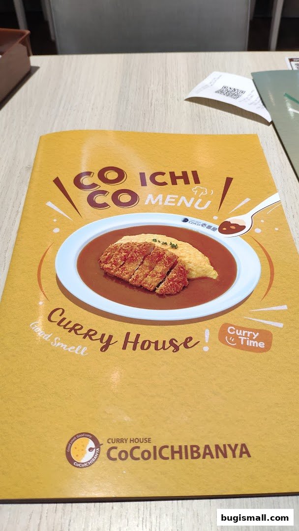 A menu from CoCo Ichibanya Curry House featuring a dish of curry with rice and a cutlet.