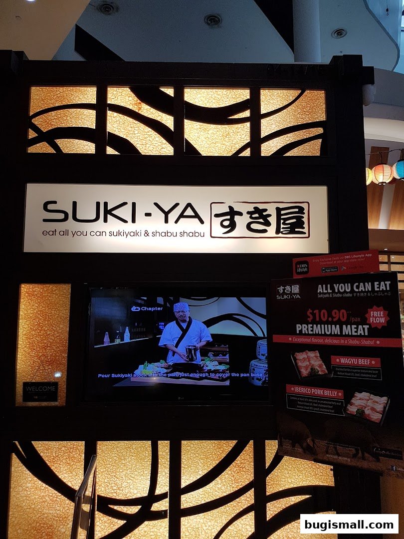 The storefront of Suki-Ya, an all-you-can-eat shabu-shabu restaurant, with a promotional display.