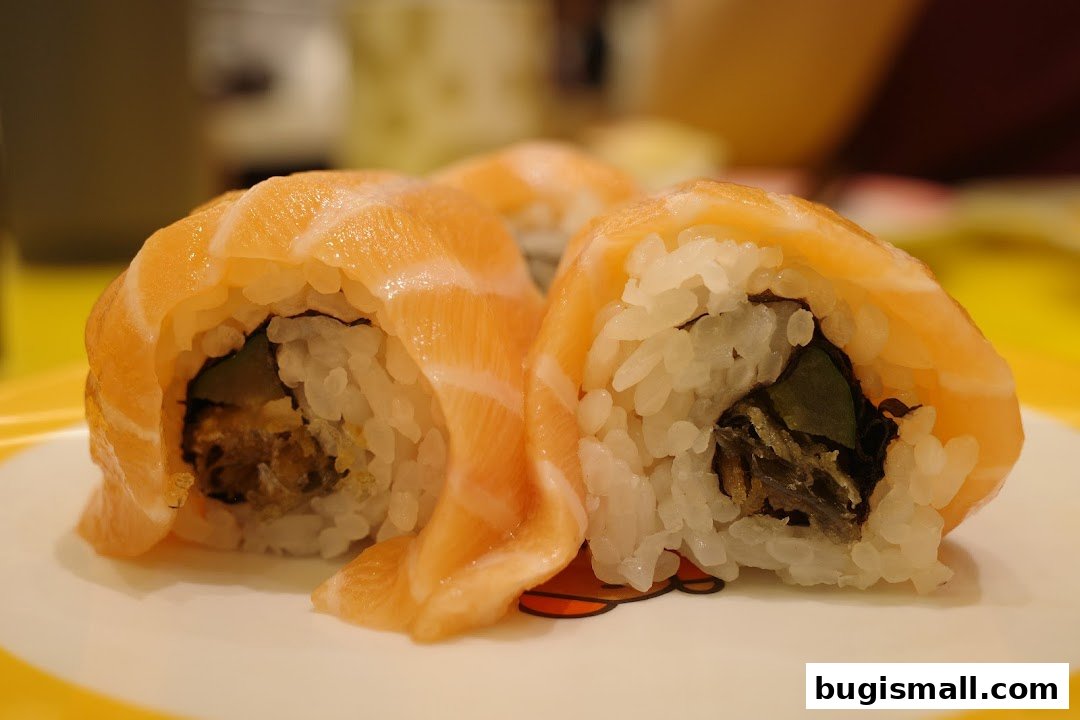 Close-up of fresh salmon sushi rolls on a plate with a cartoon design.