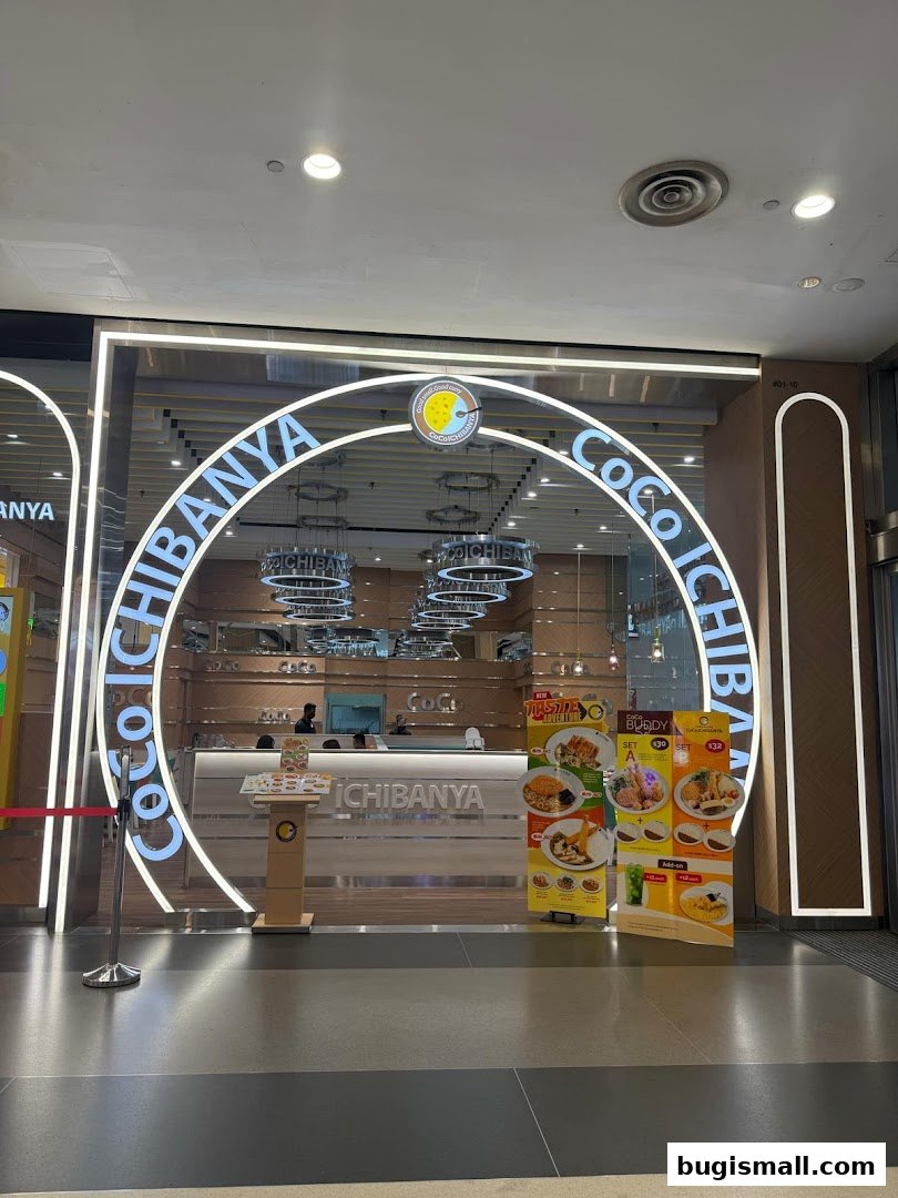 The entrance of CoCo ICHIBANYA Bugis, a Japanese curry restaurant, with promotional posters.