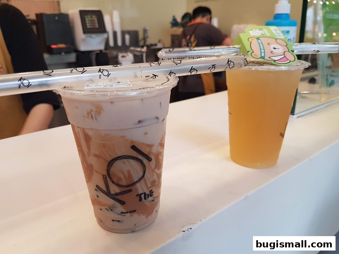 Two KOI Thé drinks, one chocolate milk tea and one iced tea, on a counter.