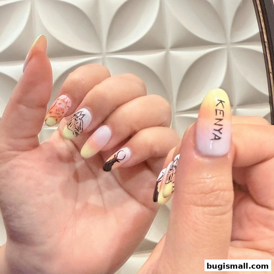 Close-up of hands with intricately designed nails featuring animal and nature motifs.