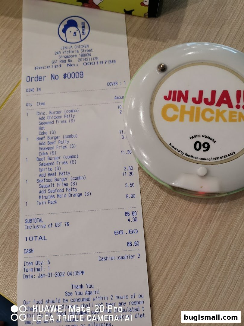 A receipt and a pager from JINJJA Chicken restaurant.