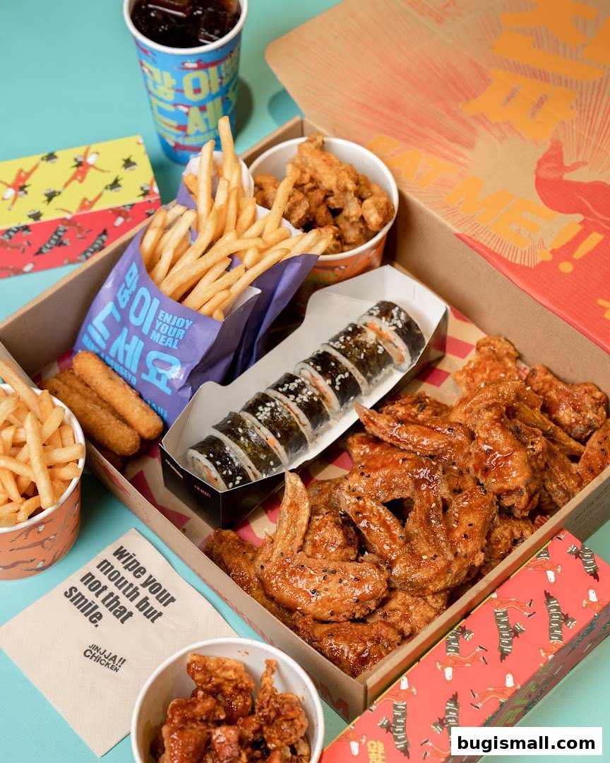 A spread of Korean fried chicken, fries, kimbap, and a drink.