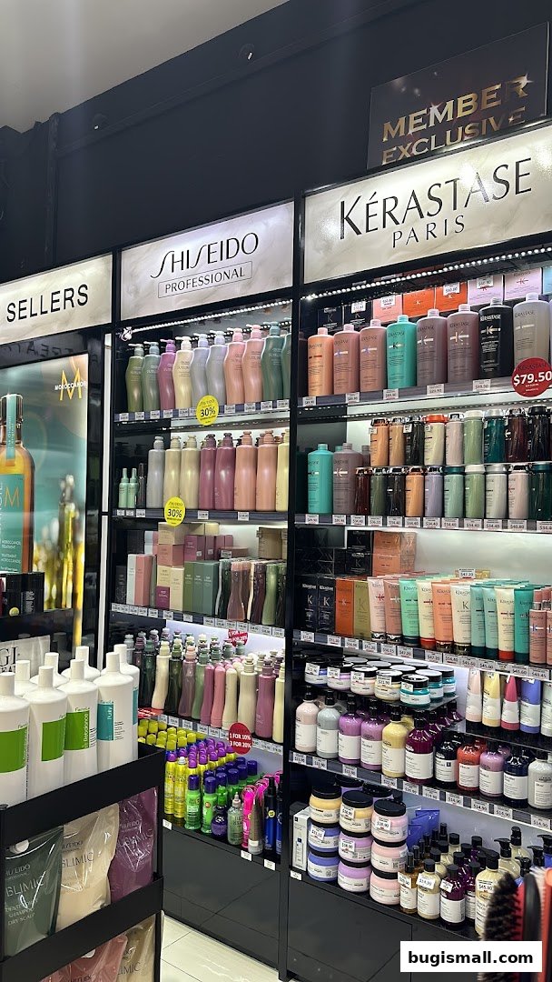 A retail display featuring various hair care products from brands like Shiseido and Kérastase.