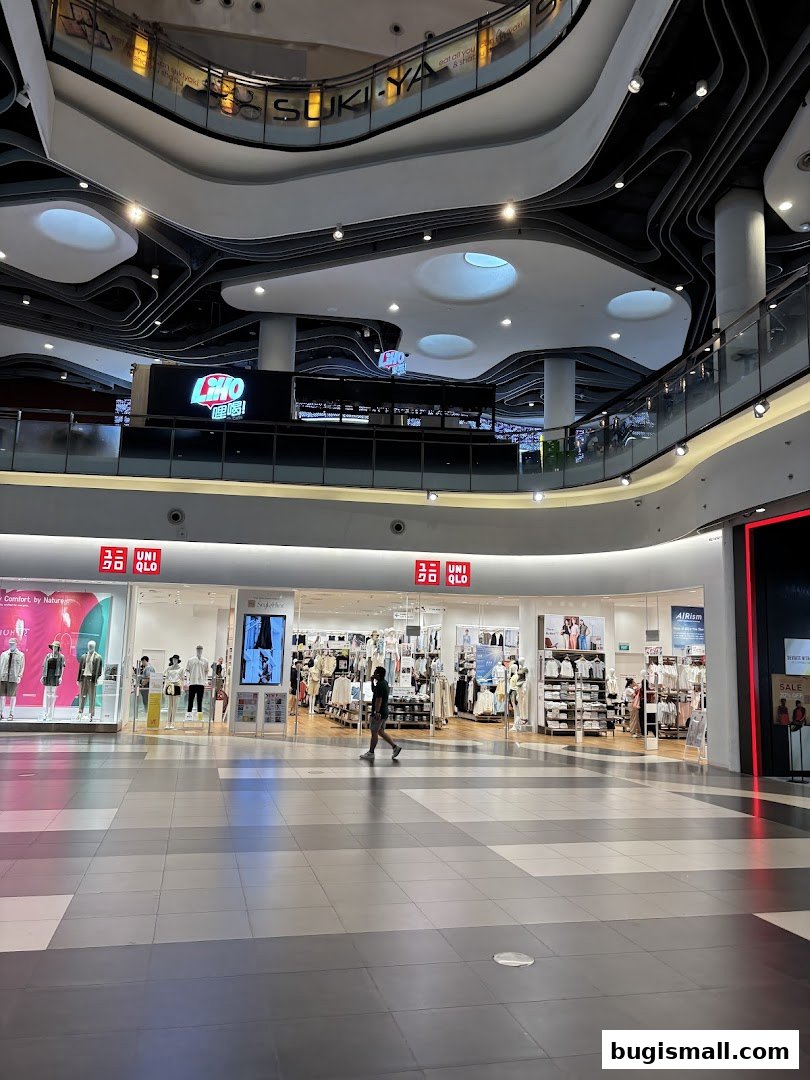 The UNIQLO Bugis store entrance with mannequins and clothing displays visible inside.