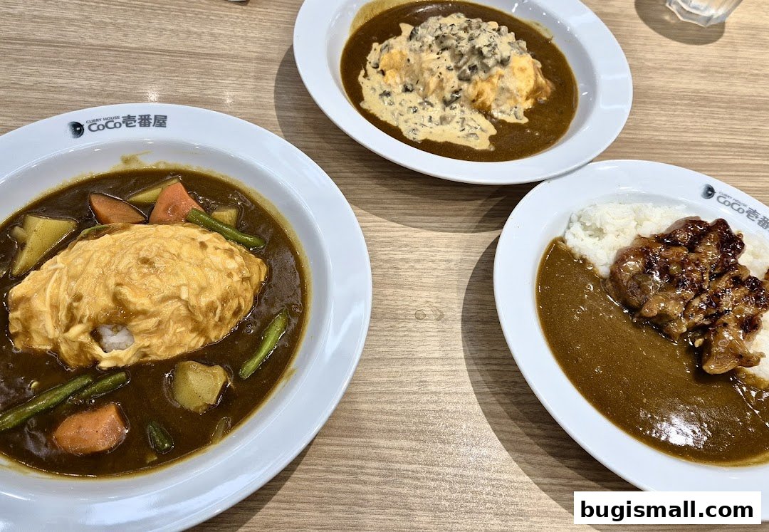 Three plates of Japanese curry with rice and various toppings, including omelet and chicken.