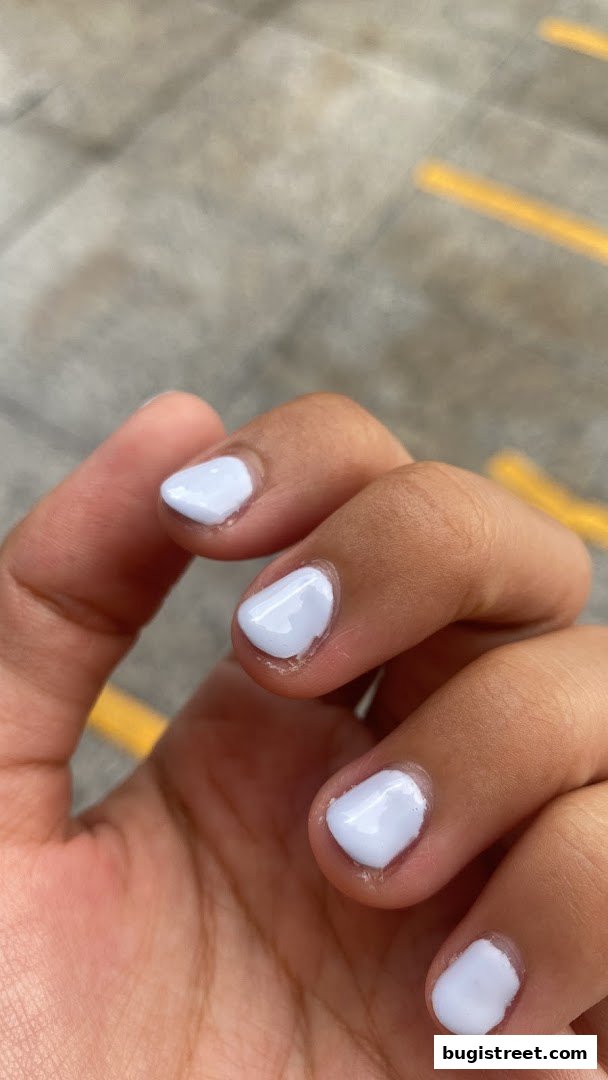 A close-up shot of a hand with neatly painted light blue nails.