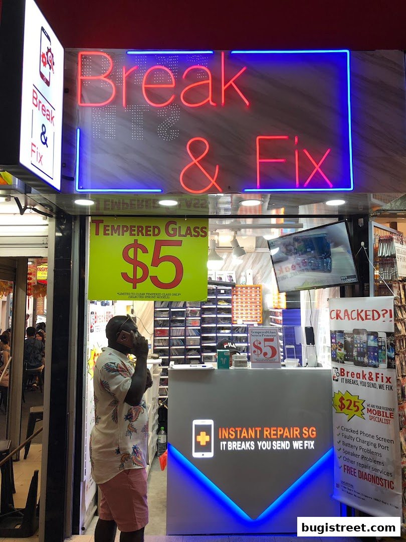 A shop front for 'Break & Fix' specializing in mobile phone repairs and accessories.
