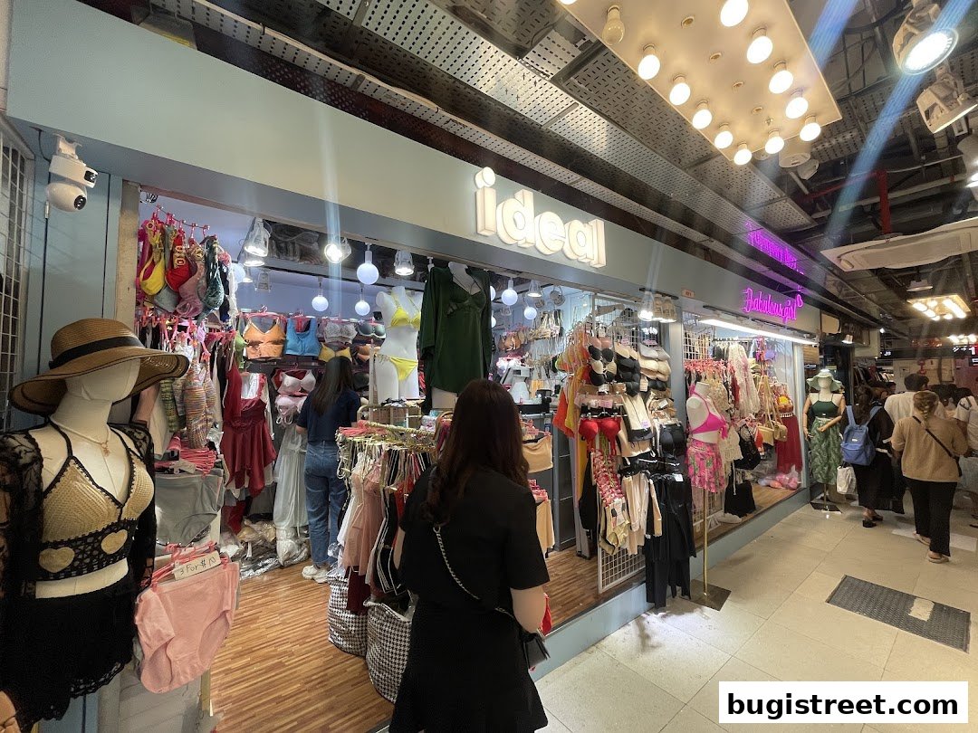 A brightly lit lingerie shop with mannequins displaying various undergarments and accessories.