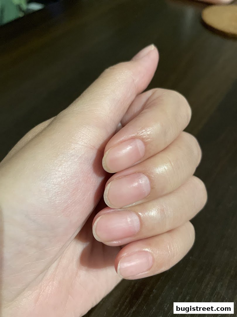 A close-up shot of a person's hands with natural, unpolished nails.