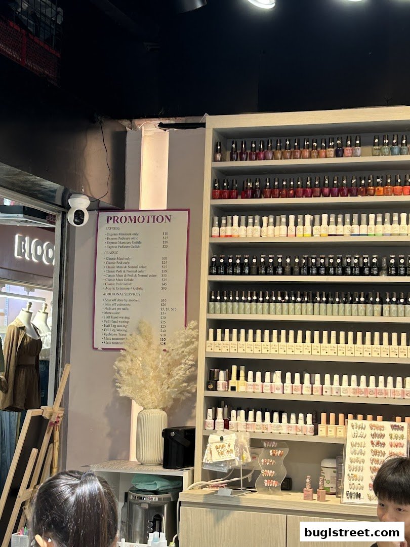 A nail salon interior with a promotion list and shelves filled with nail polish bottles.