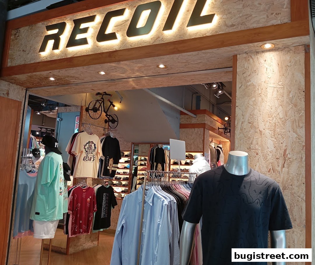The entrance of Recoil clothing store with mannequins and apparel displayed.