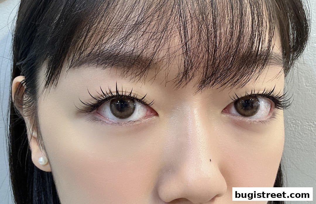 Close-up of a woman's eyes with beautifully applied eyelash extensions and subtle makeup.