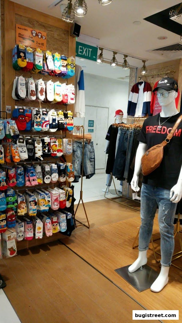 A retail shop displaying a wide variety of character-themed socks and apparel on mannequins.