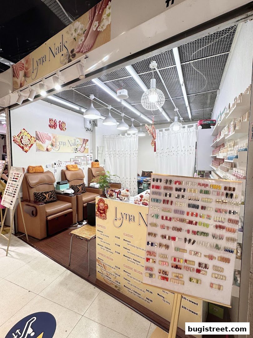 A nail salon with pedicure chairs, a display of nail art, and a price list.