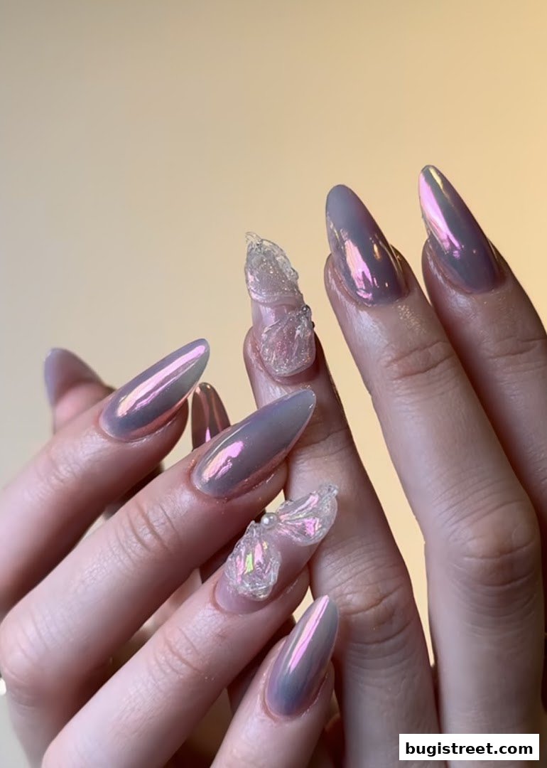 Close-up of hands with stunning iridescent chrome nails and delicate 3D nail art.