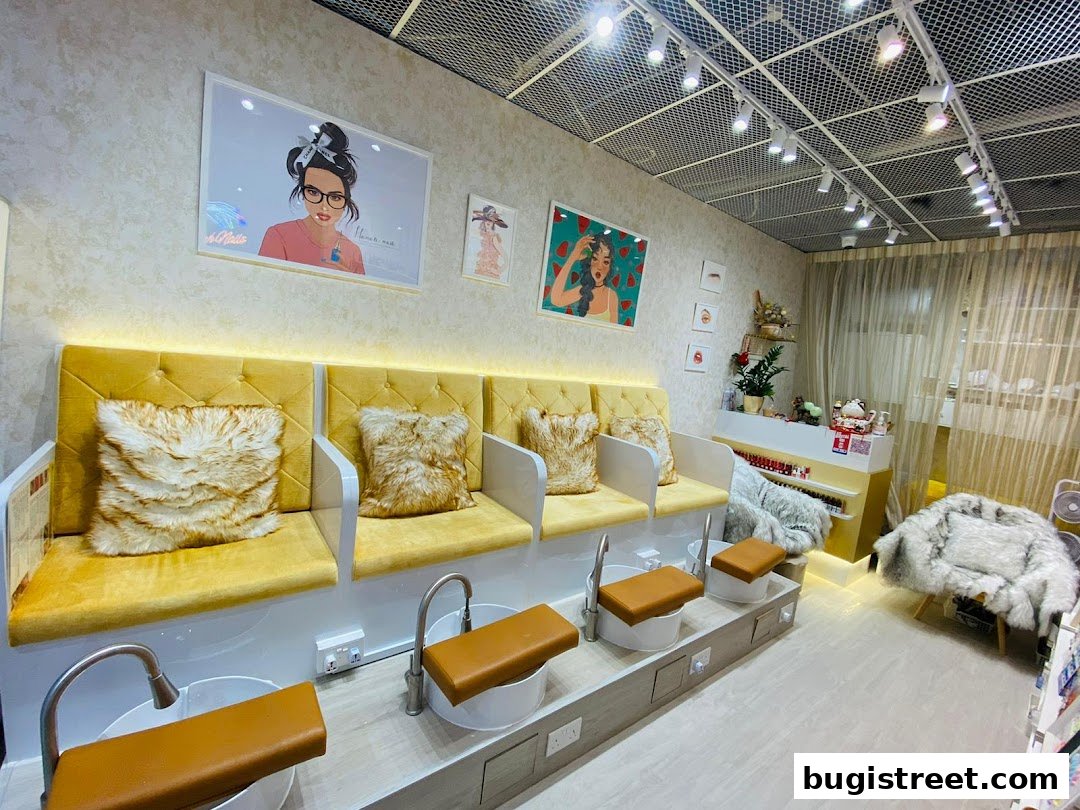 Interior of a nail salon with pedicure chairs, plush seating, and decorative art.