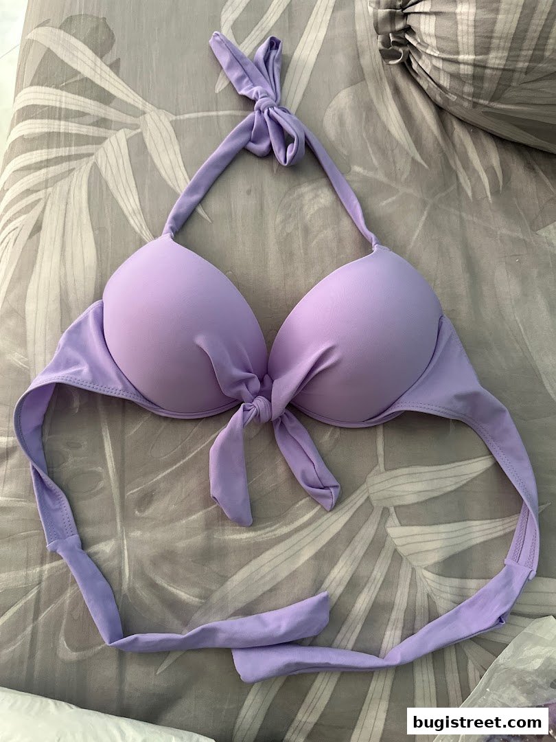 A close-up shot of a lavender bikini top with a tie front and halter neck.