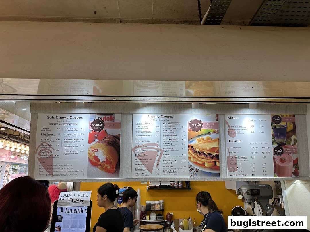 A menu board displaying various crepes, sides, and drinks at Neds Crepes & Coffee.