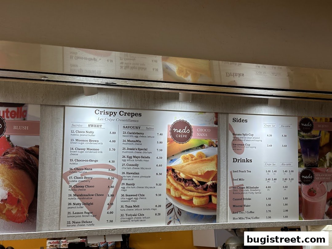 A menu board displaying crispy crepes, sides, and drinks with prices.