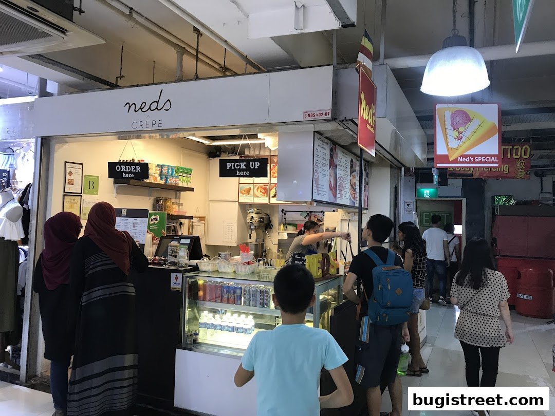 A crepe and coffee shop with customers ordering and waiting.