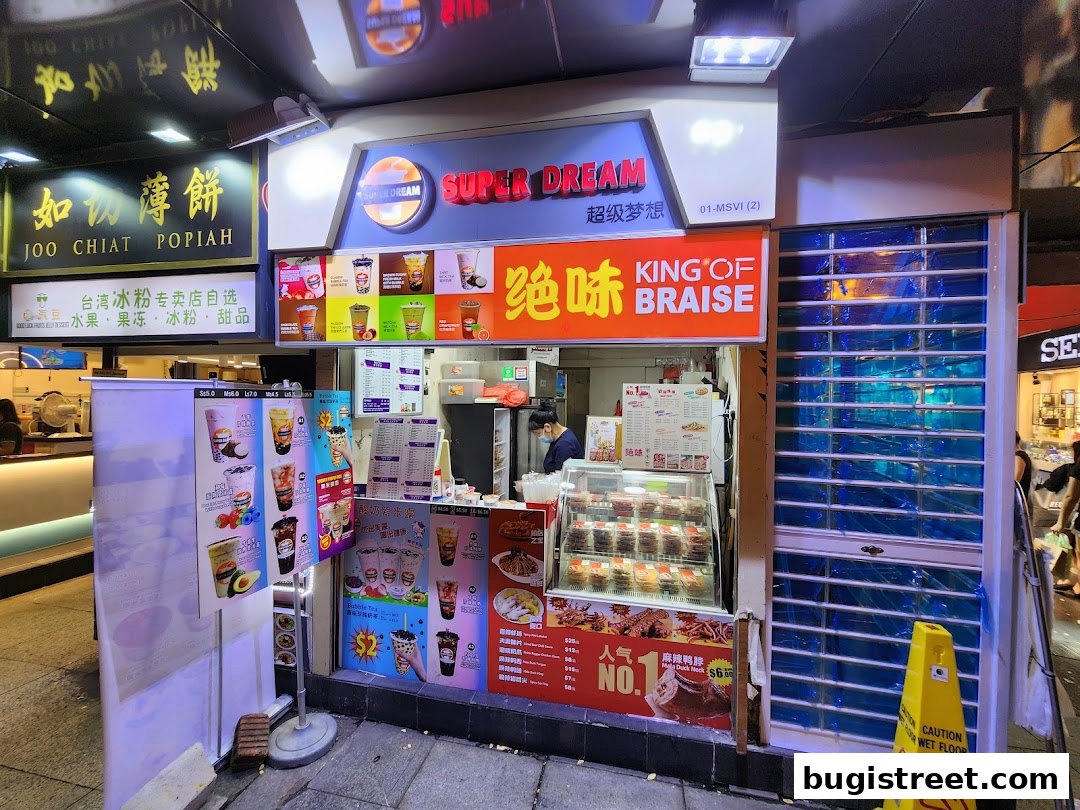 A brightly lit shop front displaying drinks, food, and a menu, with a 'King of Braise' sign.