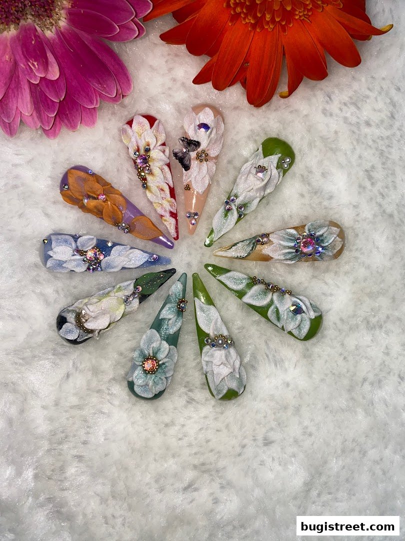 A collection of intricately designed artificial nails with floral and butterfly motifs, arranged in a circle.
