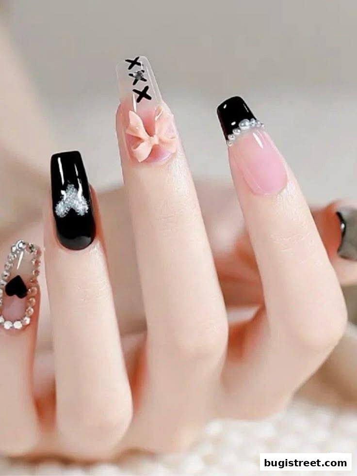 Close-up of a hand showcasing intricately designed nails with black, pink, and clear polish, adorned with gems and bows.