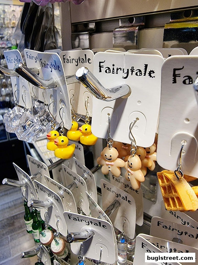 A display of quirky and fun novelty earrings, including rubber ducks, gingerbread men, and waffles.